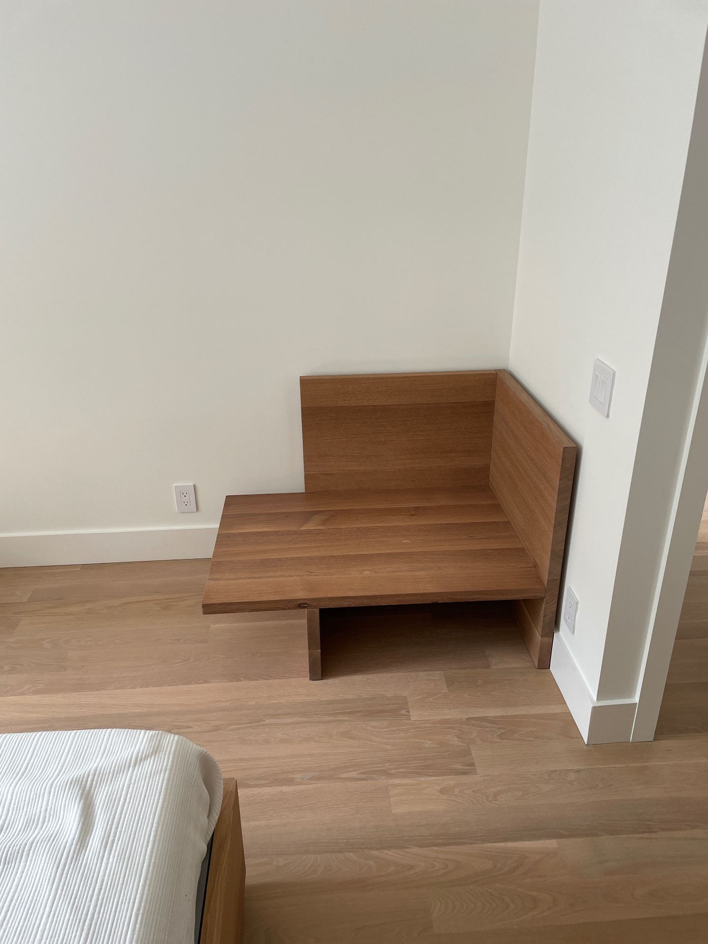 Side view of oak chaise showing cantilevered seat and back panel