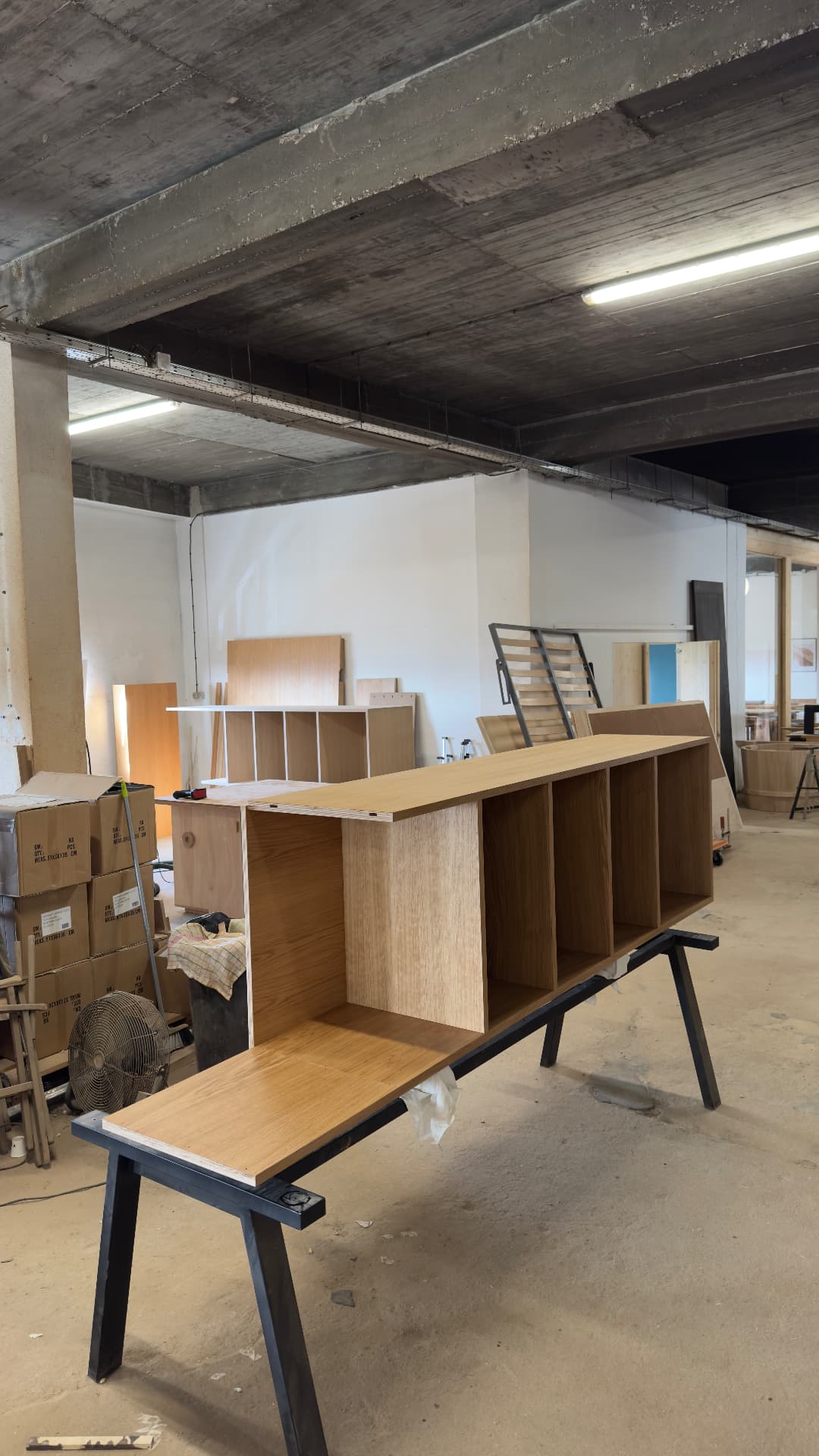 Oak credenza shell with open compartments on trestles