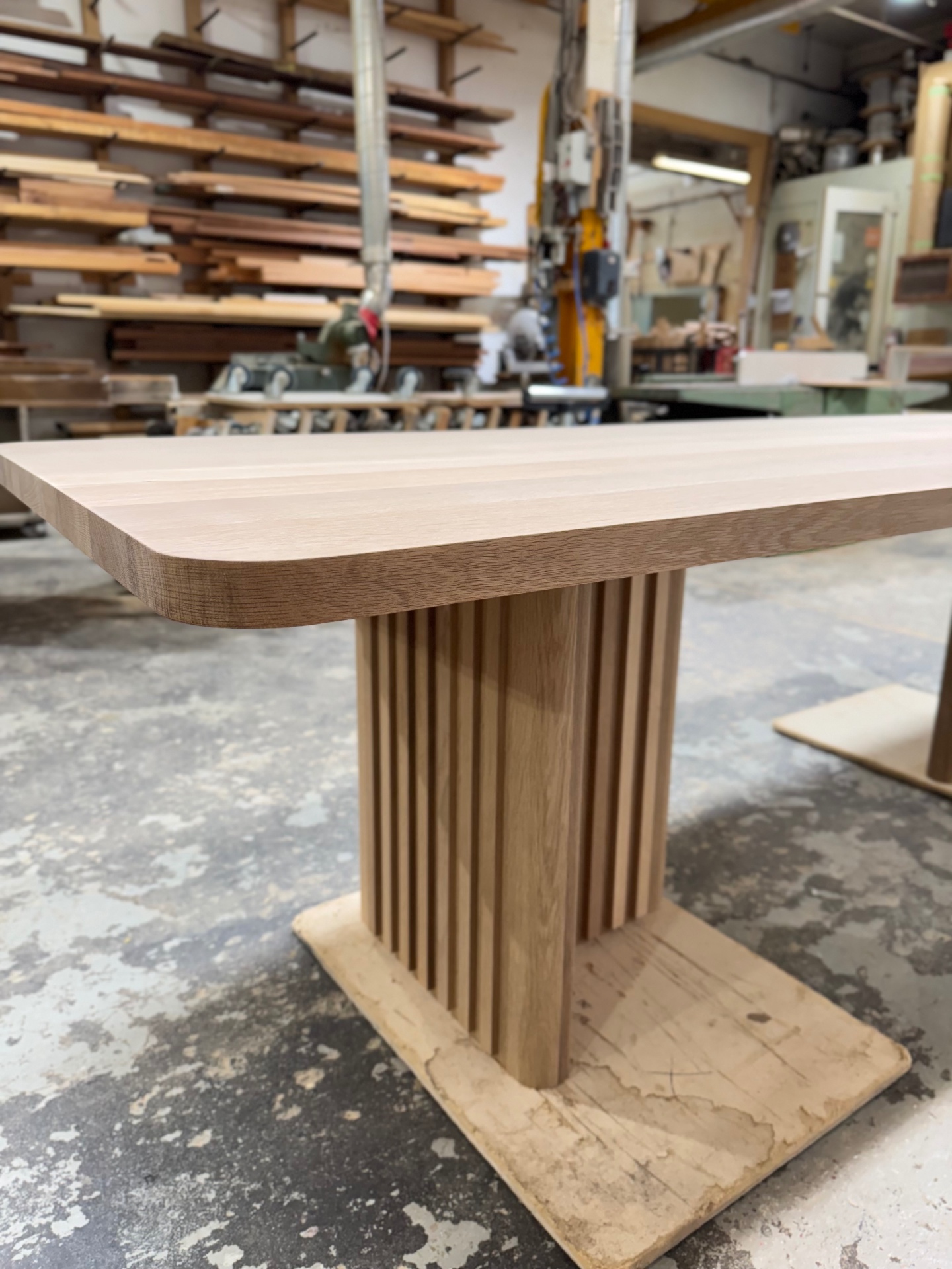 Sculpted underbevel along the oak table edge