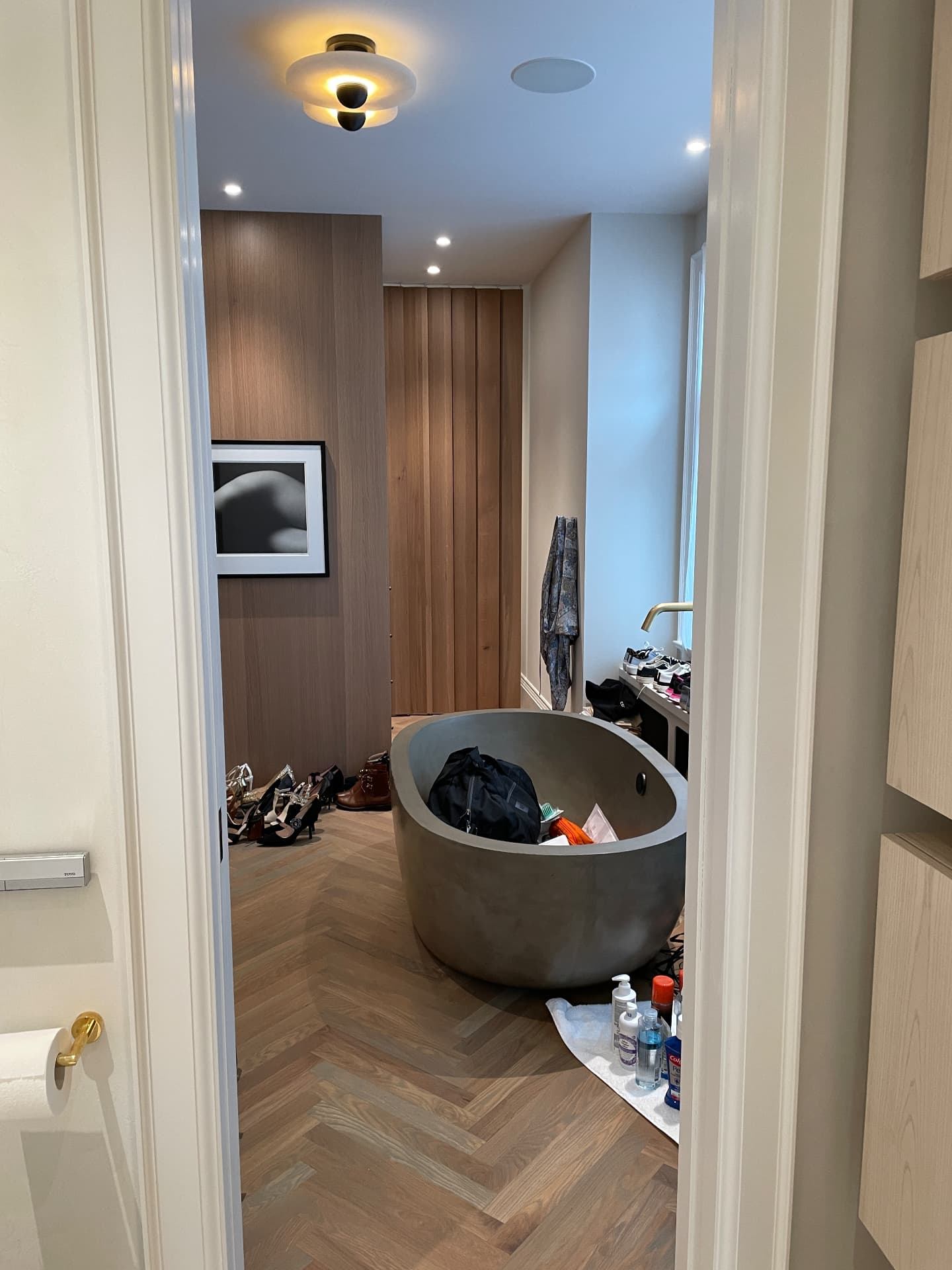 Dressing room with oak veneer panels, storage and a freestanding bath