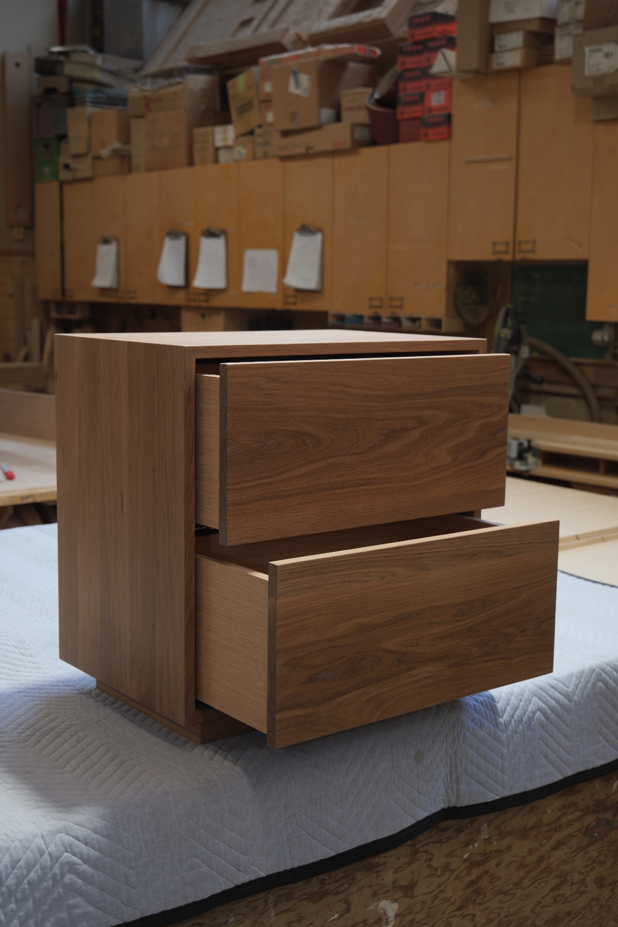 Oak nightstand with both push-to-open drawers extended