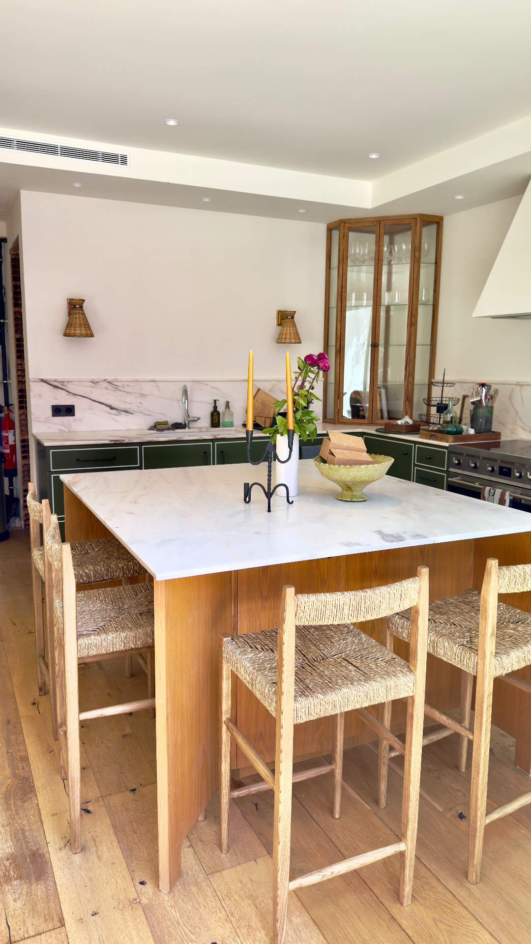 Oak island with woven barstools and marble worktop