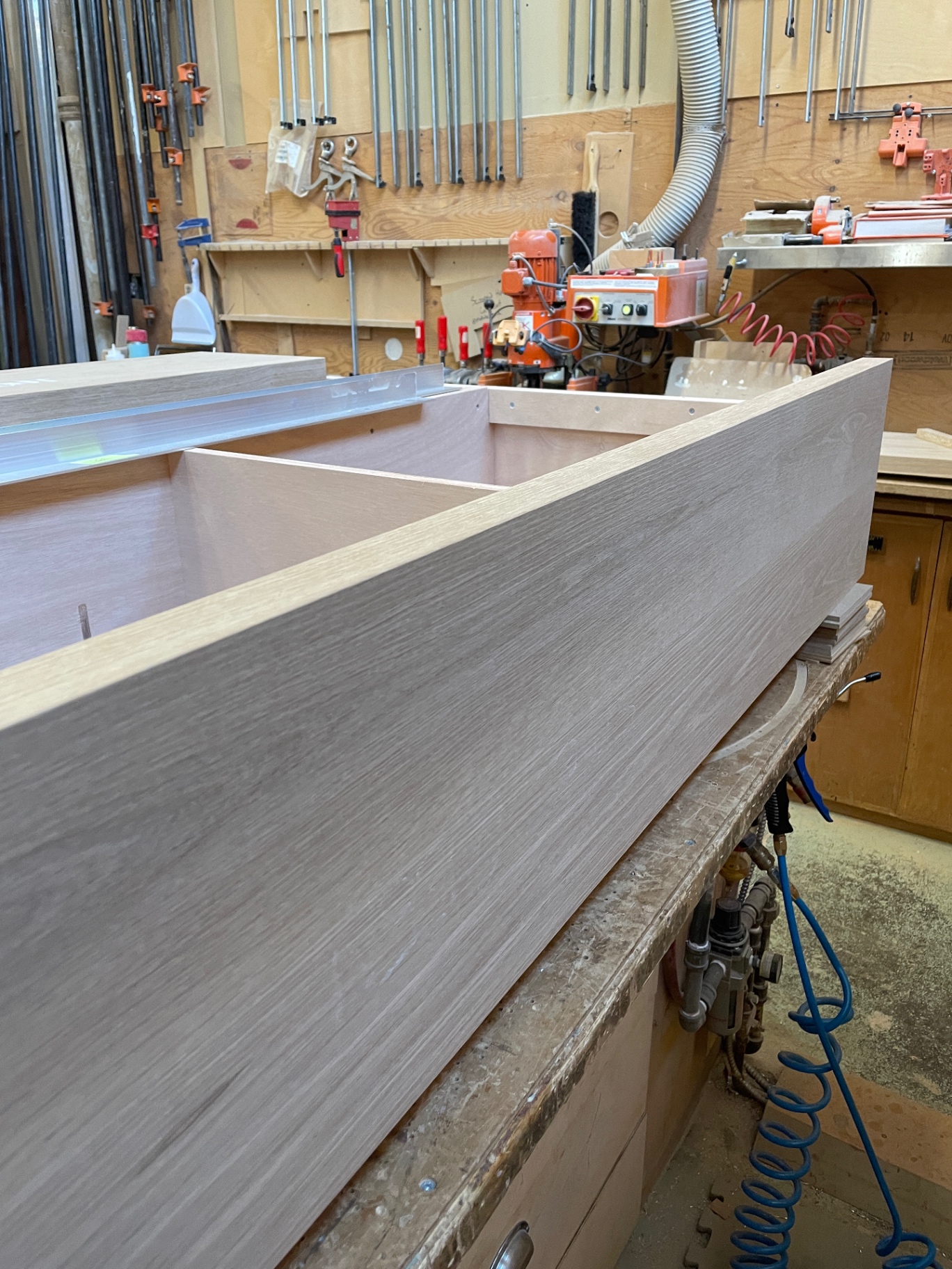 Low profile of the assembled oak bed frame in the atelier