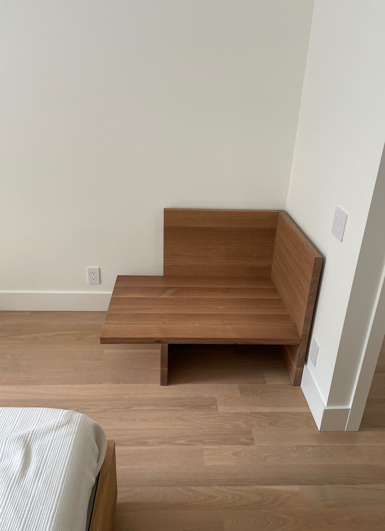Side view of oak chaise showing cantilevered seat and back panel