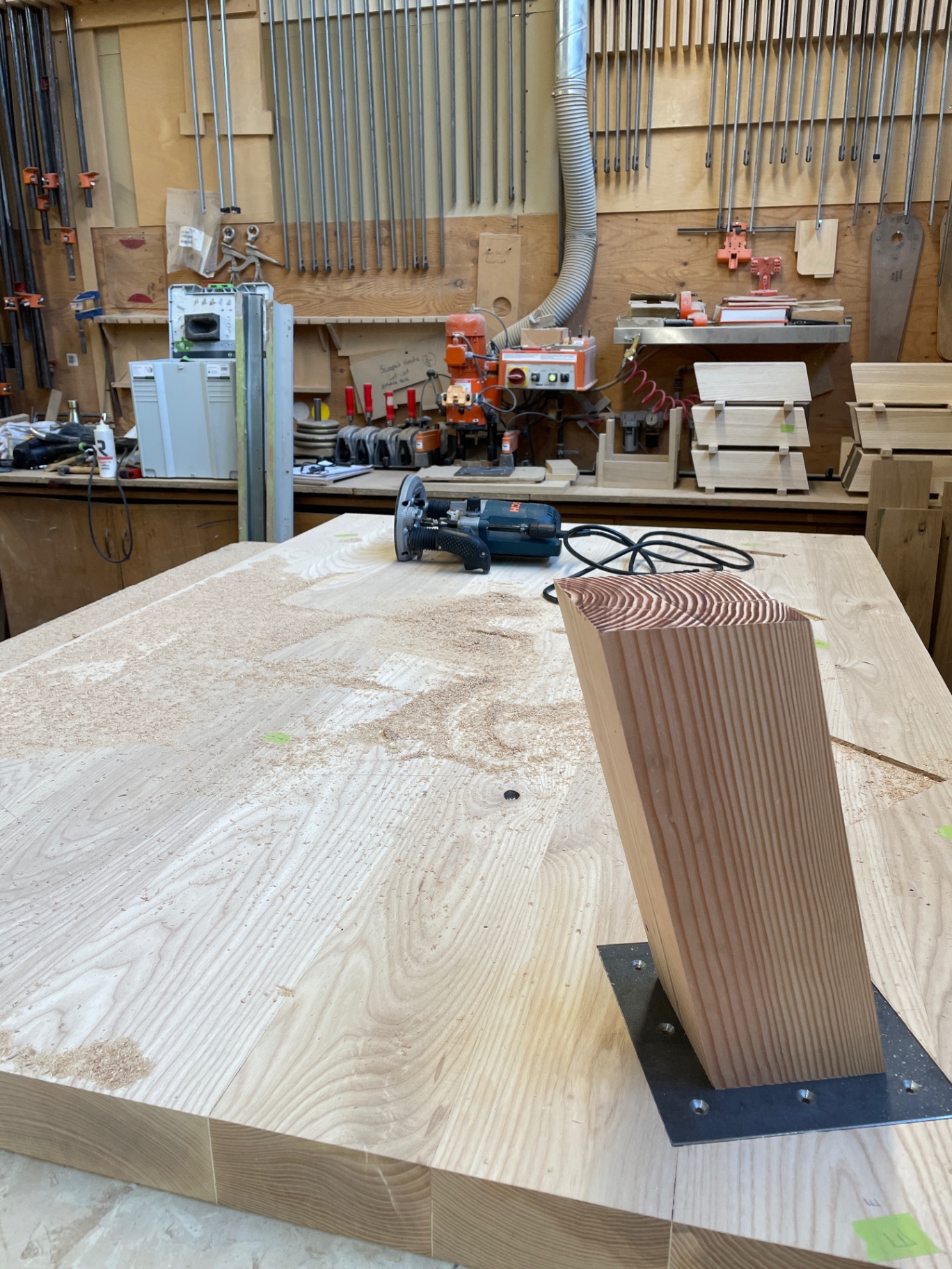 Single tapered ash leg with steel mounting plate during shaping