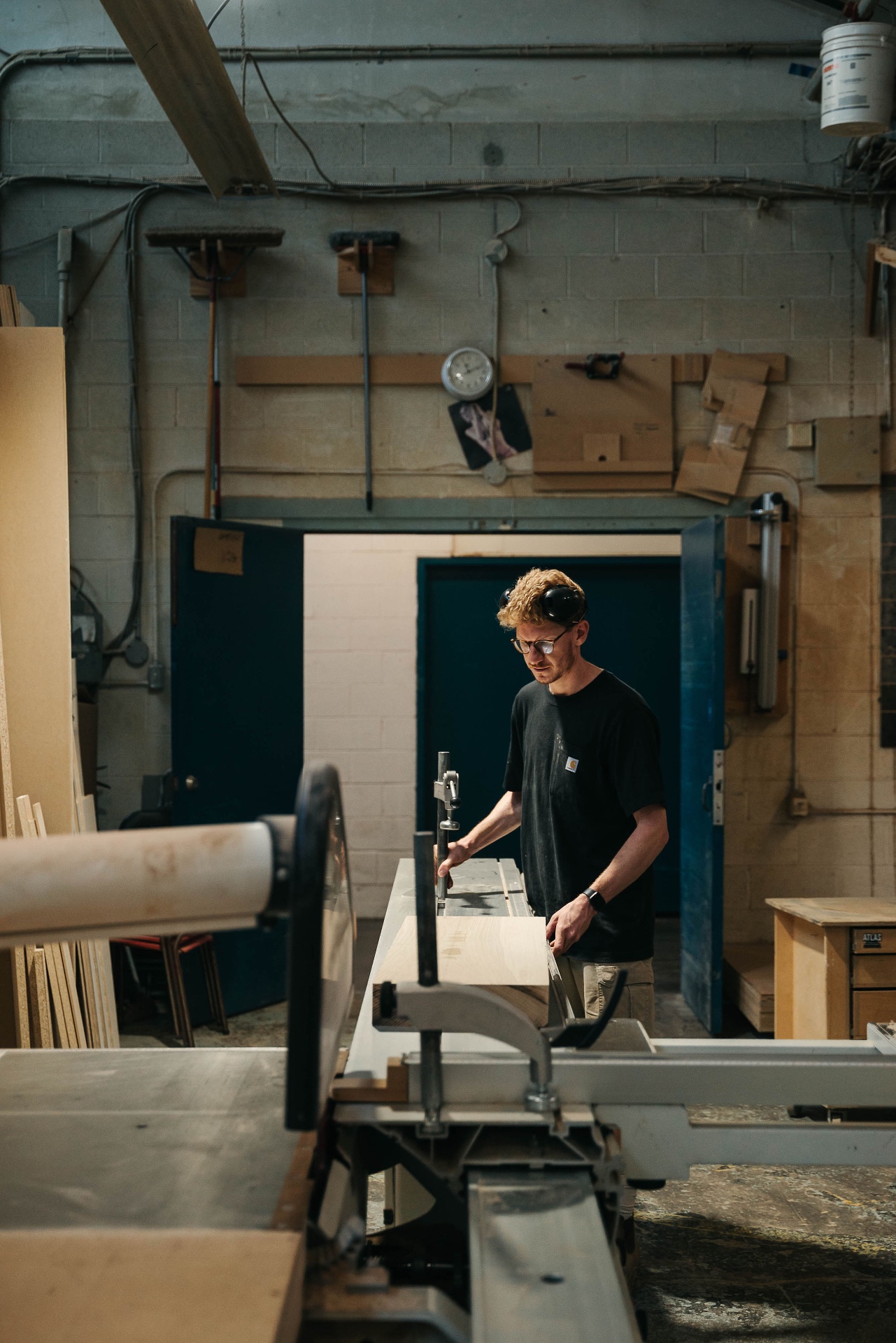 Martin guiding a board through the saw