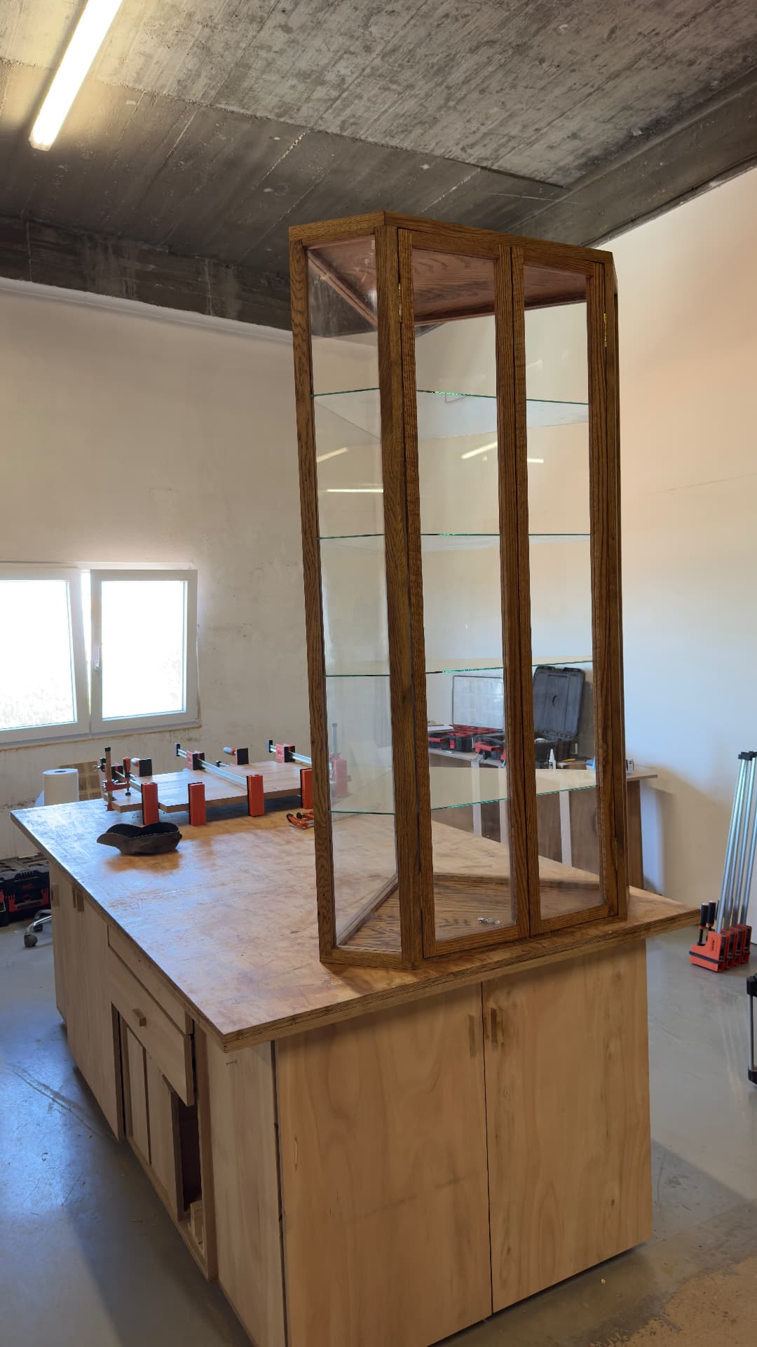 Glass and oak vitrine cabinet on the assembly bench