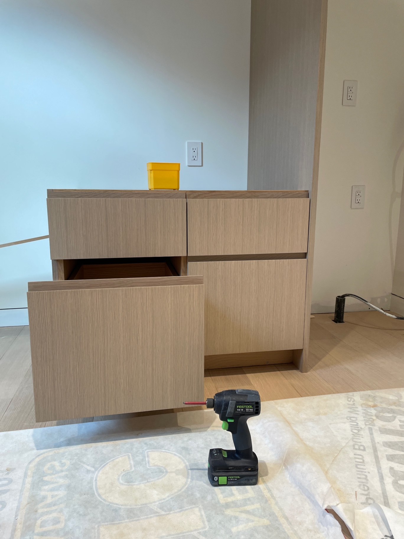 Oak drawer pulled open showing dovetailed box and soft-close slide
