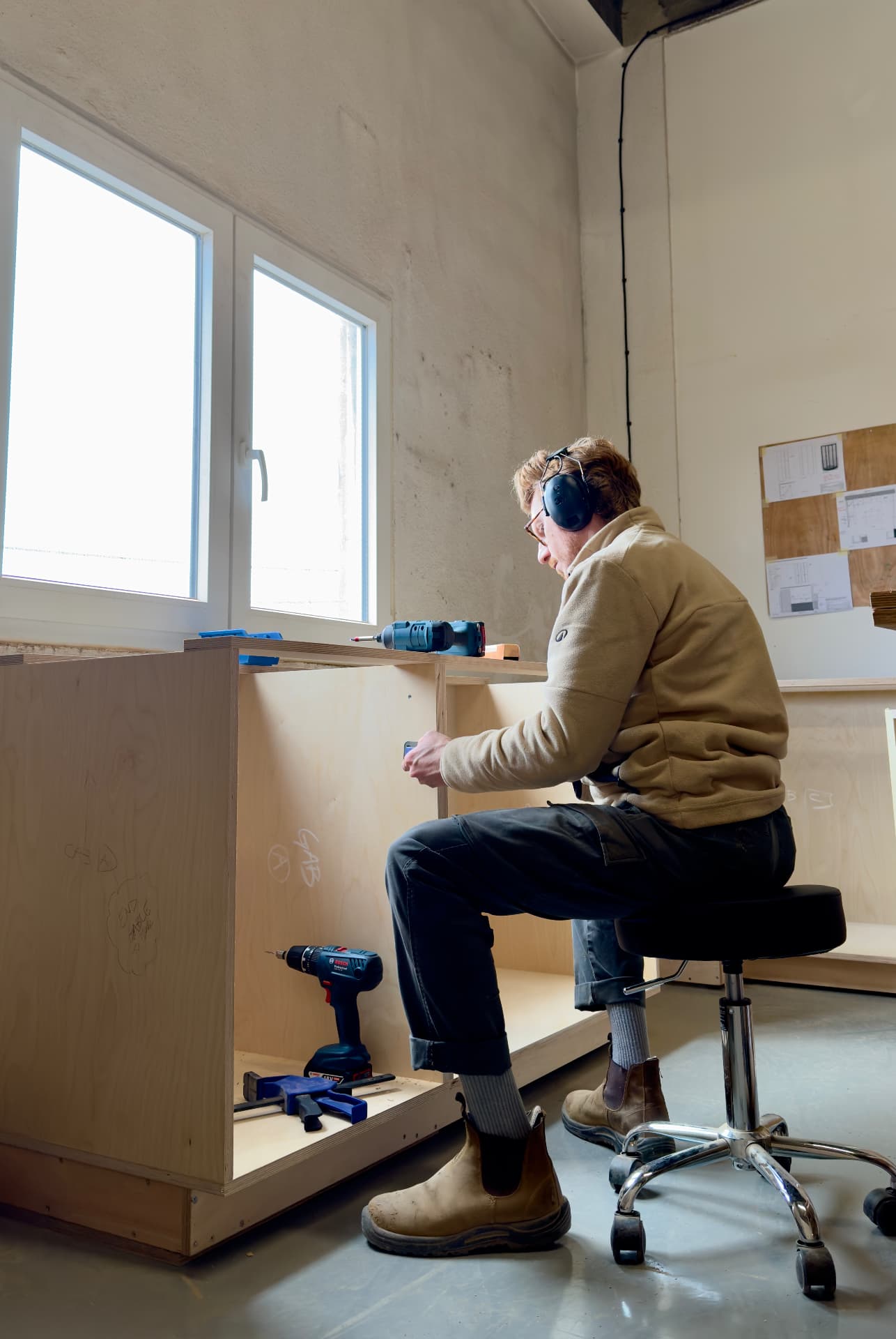Assembling a cabinet carcass by the window