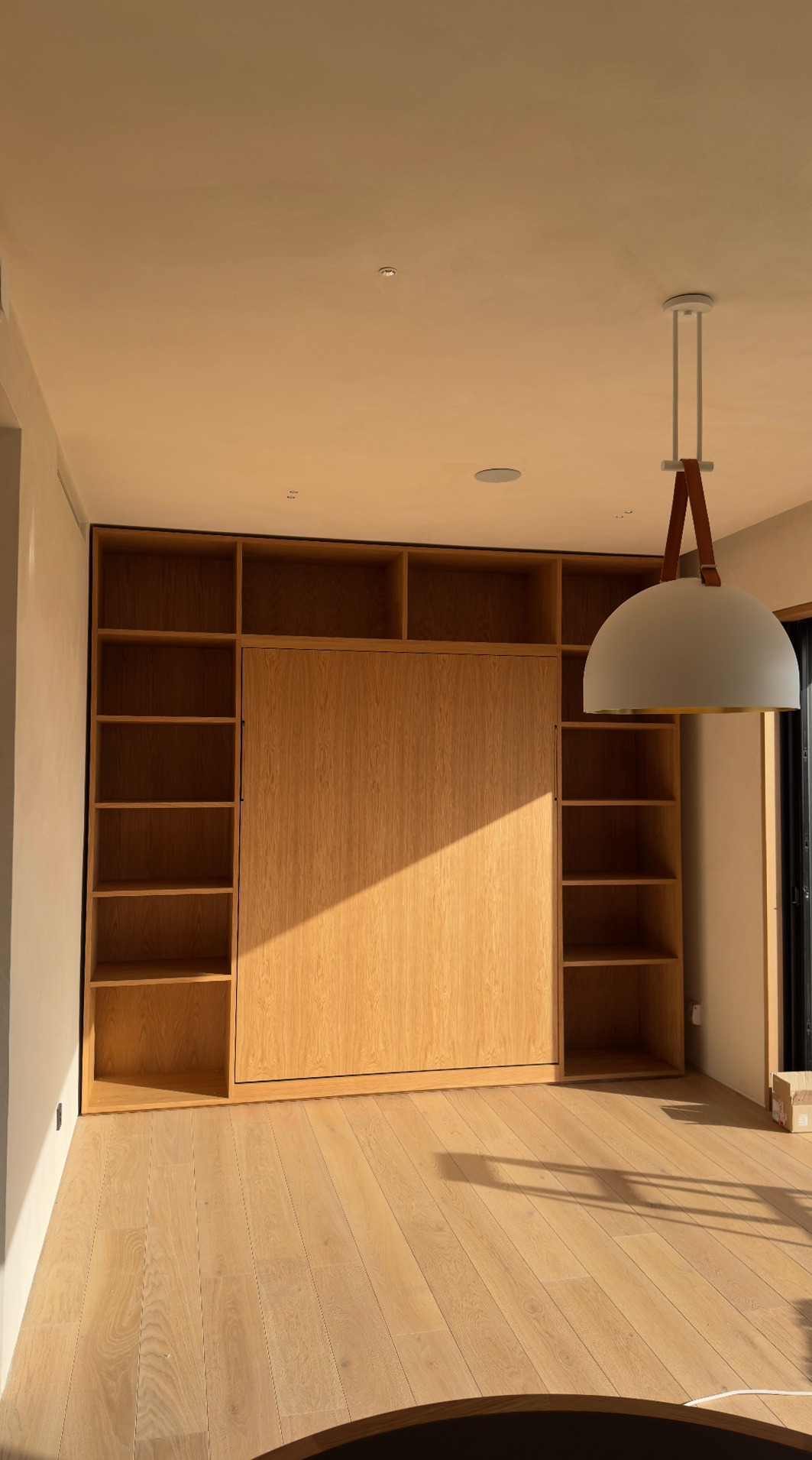 Bespoke oak wall unit with concealed murphy bed, closed
