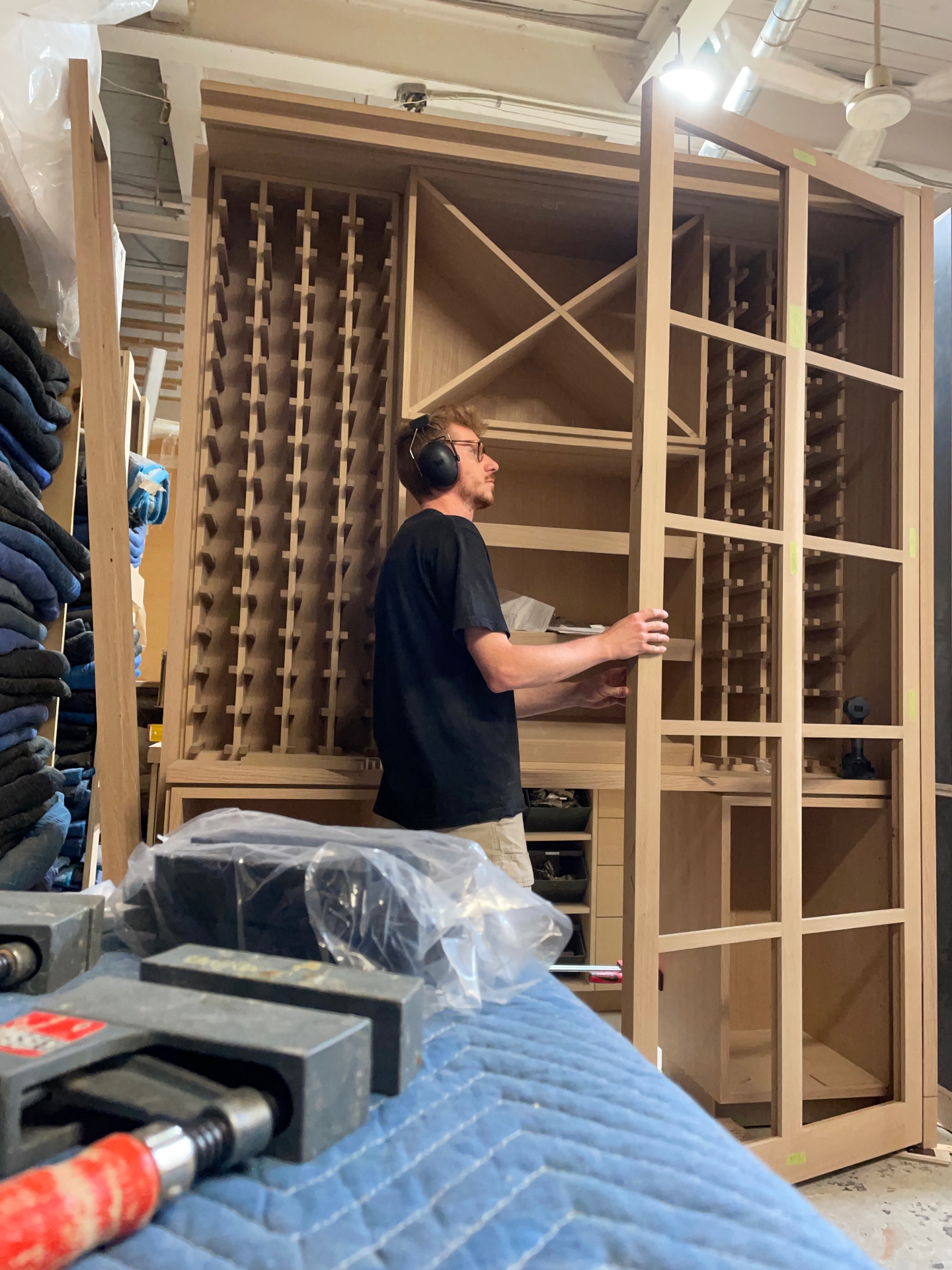Martin fitting an oak shelf into the wine cellar carcass