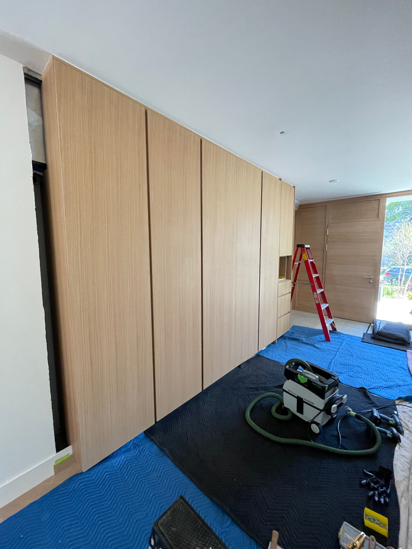 Entryway closet with rift-oak fronts installed during fit-out