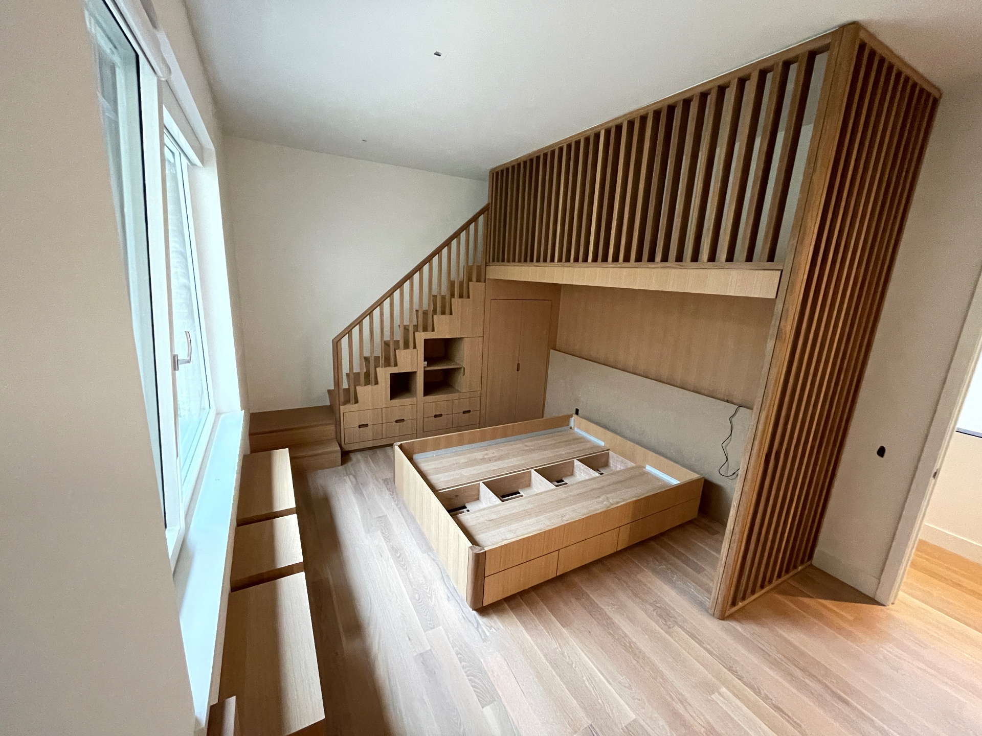 Full oak kids' room built-in with loft, lower bed and window bench
