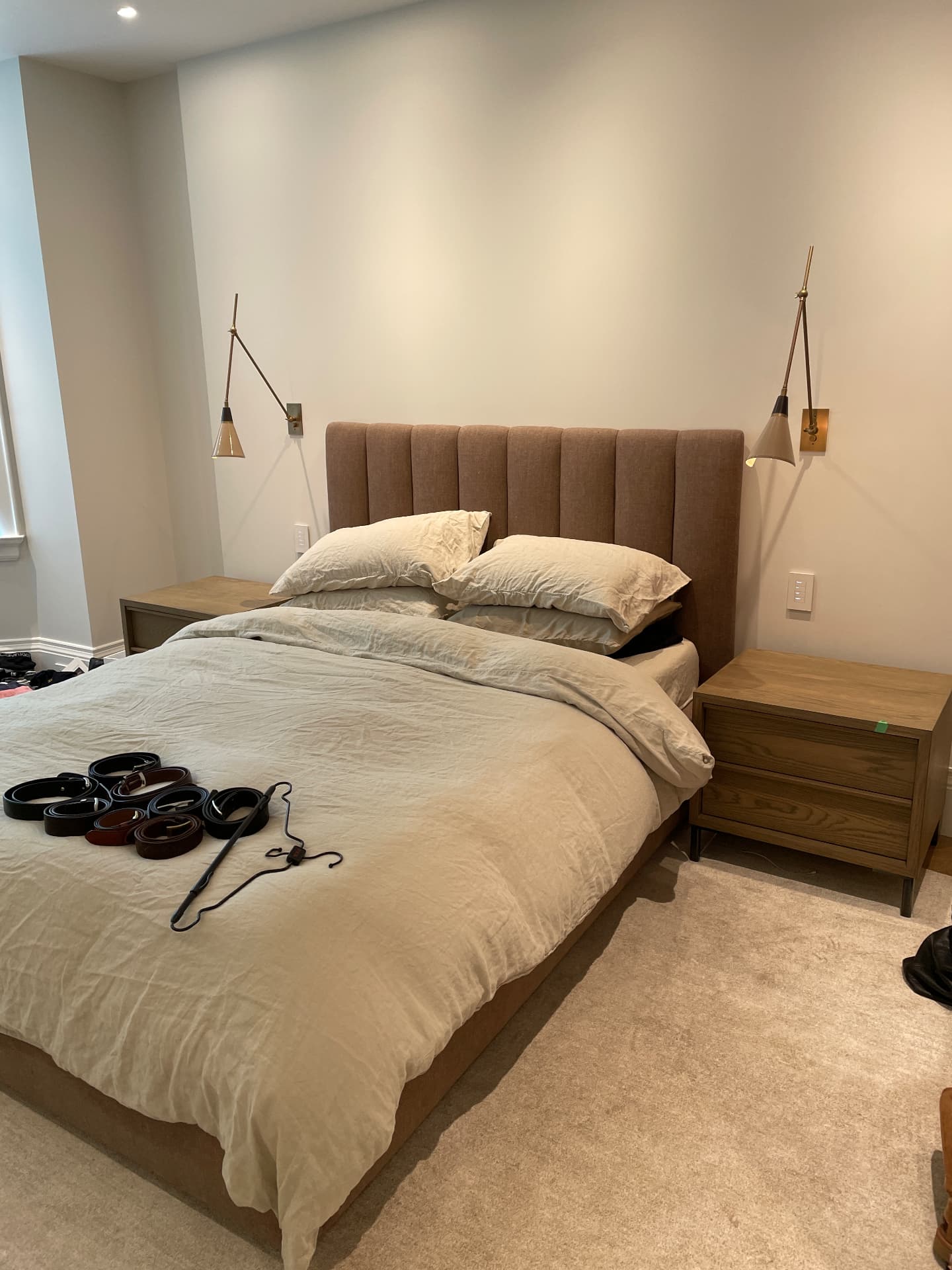 Bedroom with oak nightstands and a slatted oak wall behind the bed