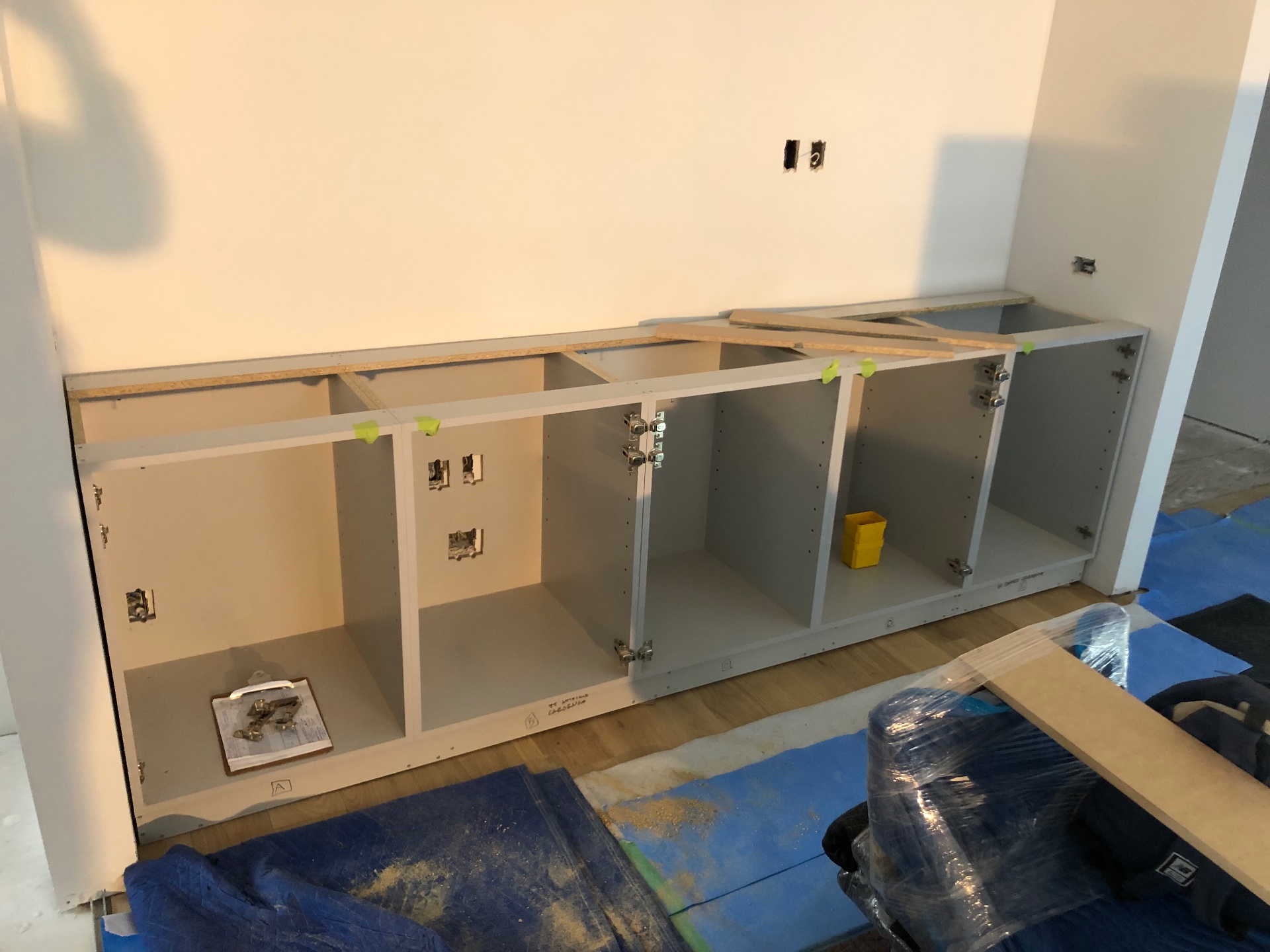 Laminate carcasses installed on site with hinges ready for the fluted doors