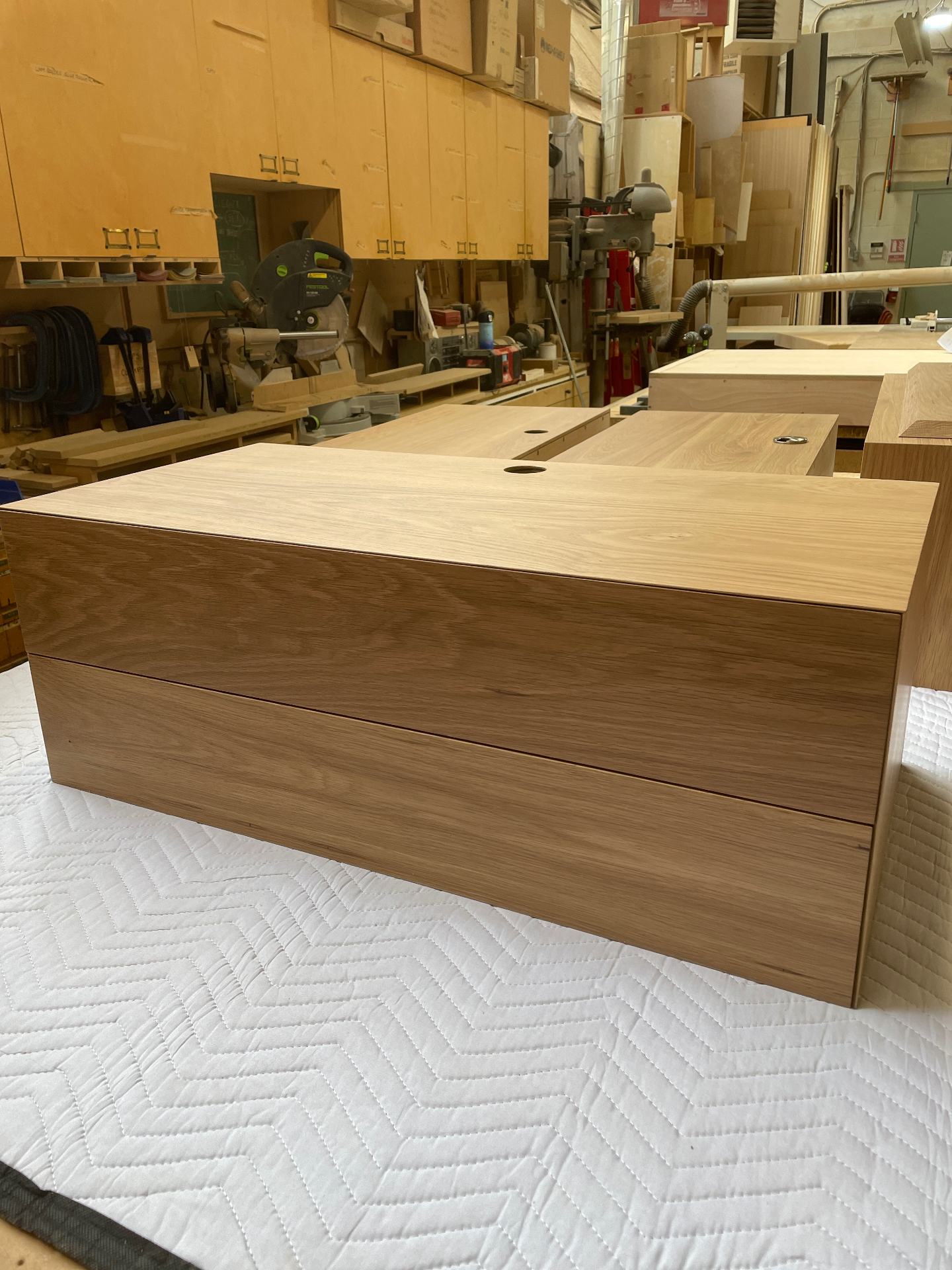 Pair of solid oak floating nightstands lined up in the workshop