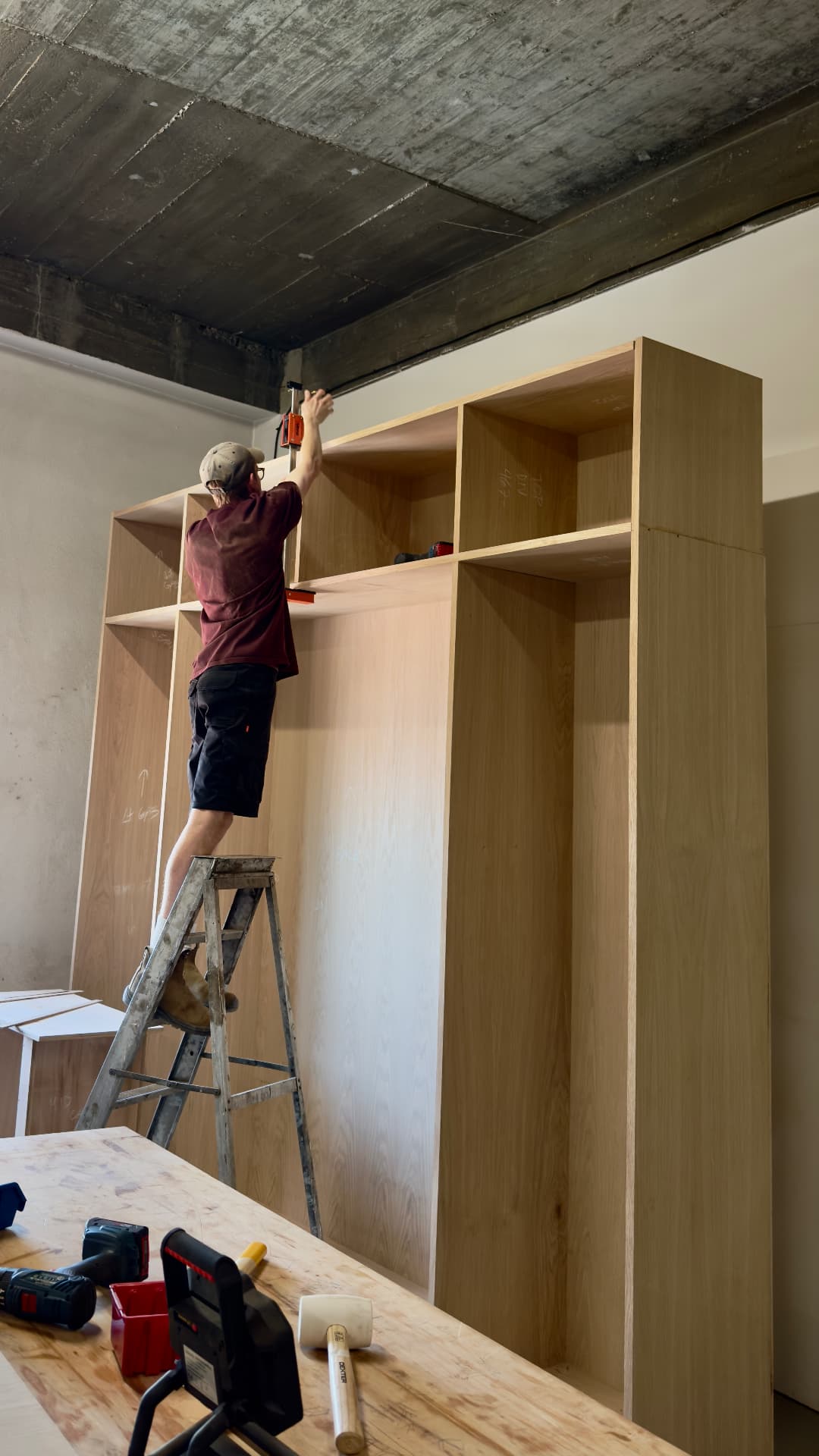 Levelling the top boxes of a wardrobe from a ladder