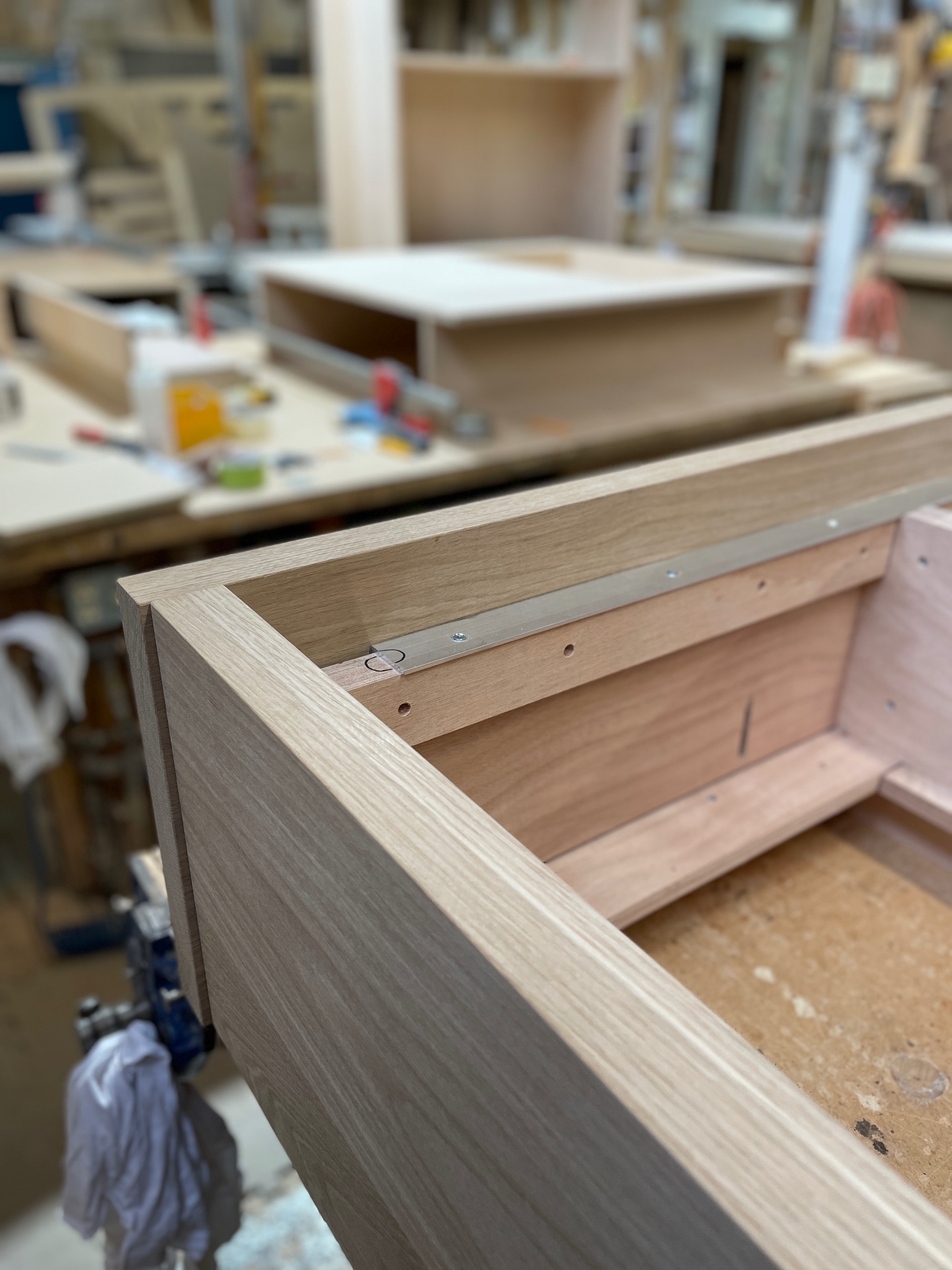 Close-up of mitred oak corner and aluminium slat ledger on the bed frame