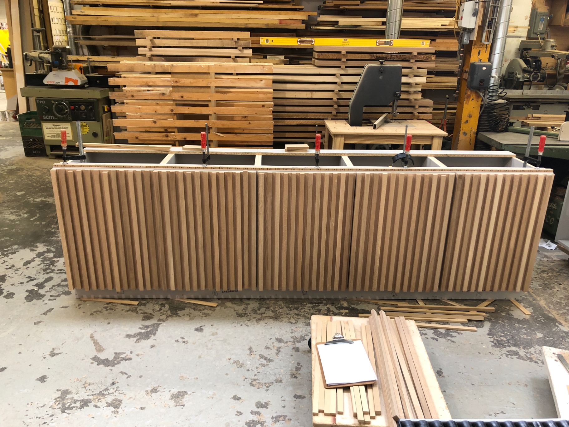 Credenza clamped up in the workshop with fluted oak doors dry-fitted